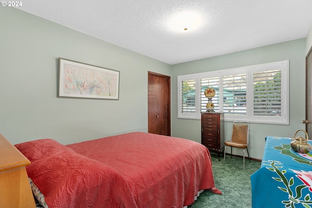 carpeted bedroom featuring a textured ceiling