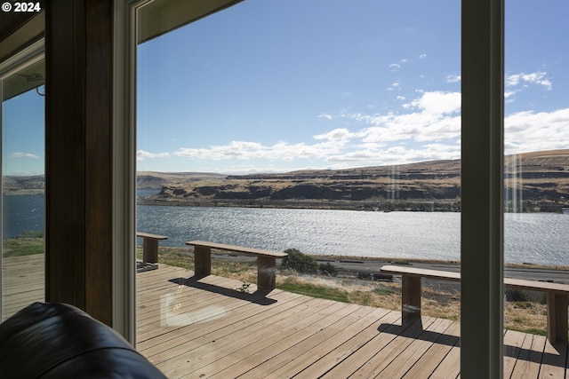 view of dock featuring a deck with water view