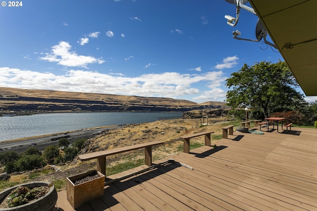 wooden deck featuring a water and mountain view