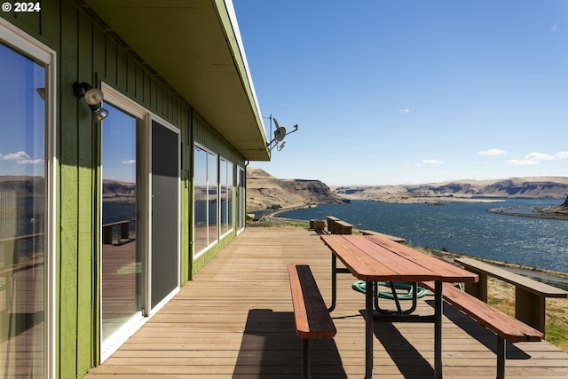 exterior space with a water and mountain view