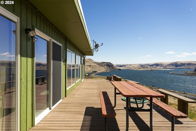 view of dock with a water and mountain view