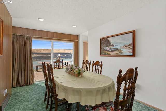 carpeted dining area featuring recessed lighting, baseboards, and a textured ceiling