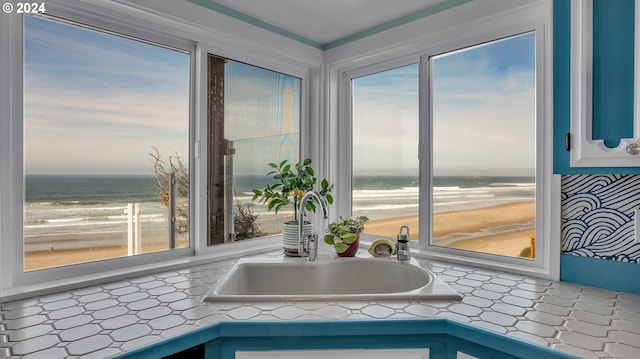 interior details featuring a water view and sink