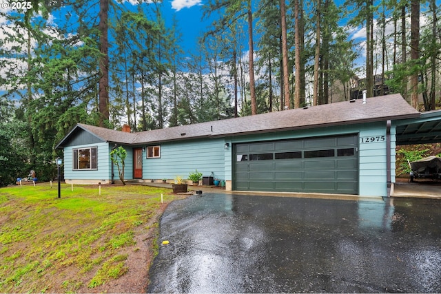 single story home featuring a front lawn and a garage