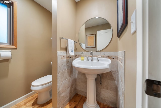 bathroom featuring toilet and wood-type flooring