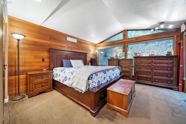 bedroom featuring carpet flooring, wooden walls, and vaulted ceiling