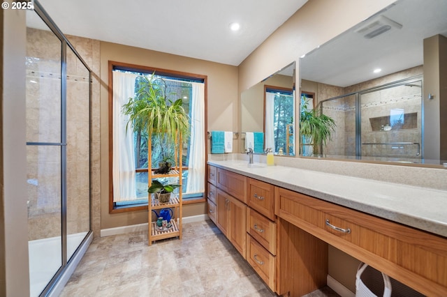 bathroom with vanity and a shower with shower door