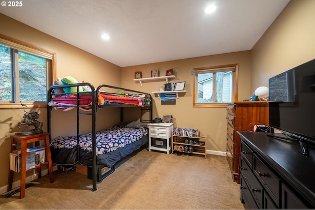 carpeted bedroom featuring multiple windows