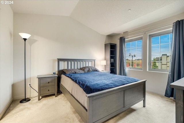 carpeted bedroom featuring lofted ceiling