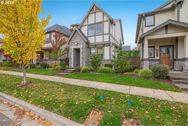 english style home featuring a front yard