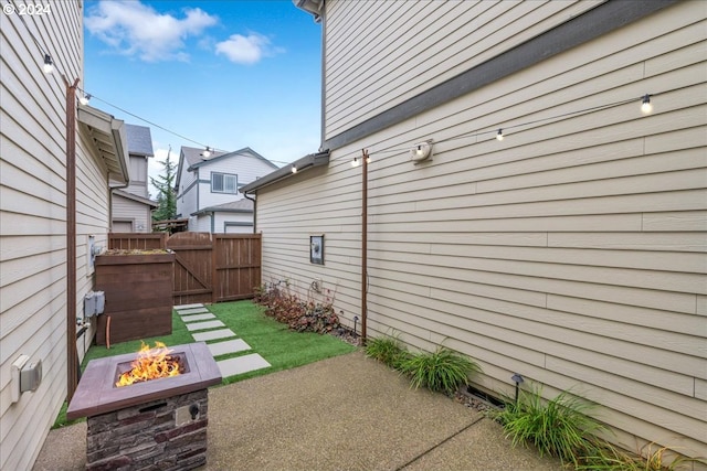 view of yard featuring a patio area and an outdoor fire pit