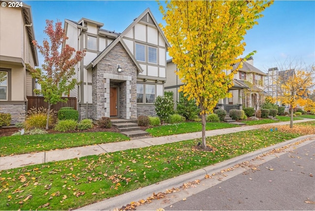 tudor-style house with a front lawn