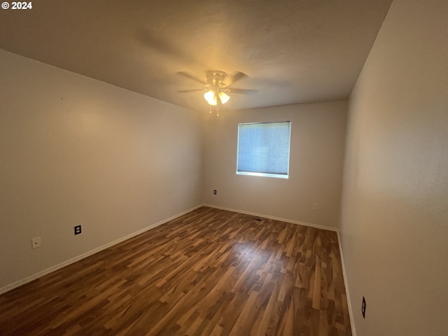 unfurnished room featuring ceiling fan and dark hardwood / wood-style flooring