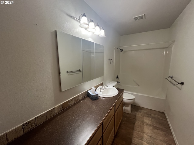 full bathroom featuring washtub / shower combination, vanity, and toilet