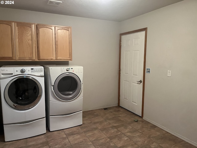 laundry area featuring cabinets and washing machine and dryer