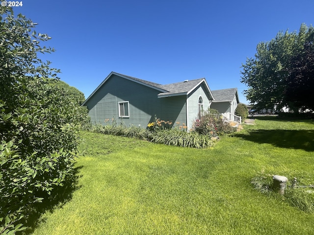 view of side of home with a lawn