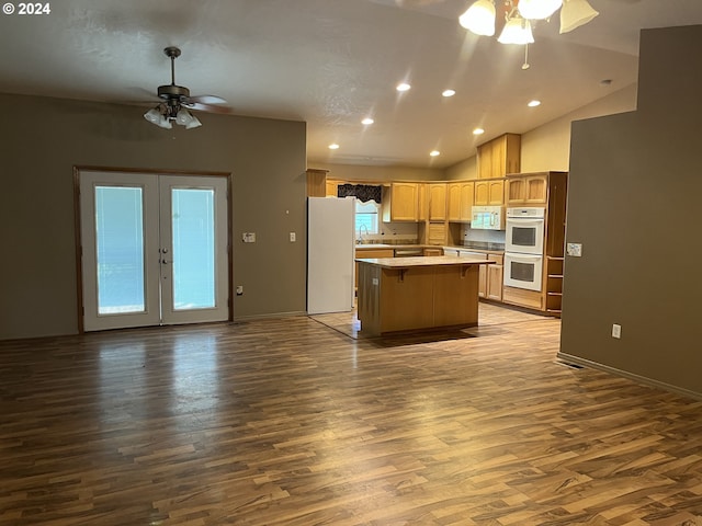 kitchen featuring white appliances, a center island, ceiling fan, french doors, and hardwood / wood-style flooring