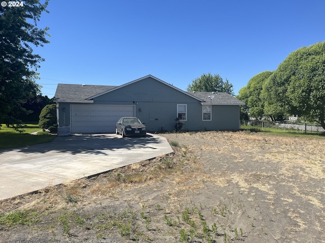 rear view of house with a garage