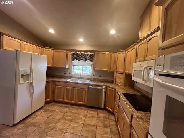 kitchen with light brown cabinets, lofted ceiling, sink, and white appliances