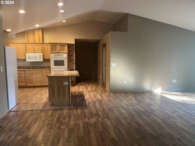 kitchen featuring a center island, lofted ceiling, white appliances, dark hardwood / wood-style flooring, and light brown cabinetry