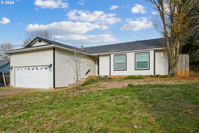 ranch-style home featuring a garage and a front lawn