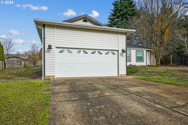 front of property featuring a front lawn and a garage