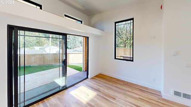 94256 11th St, Gold Beach, OR 97444 - doorway with plenty of natural light, light wood finished floors, and baseboards
