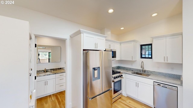 94256 11th St, Gold Beach, OR 97444 - kitchen with appliances with stainless steel finishes, a sink, healthy amount of natural light, white cabinetry, and recessed lighting