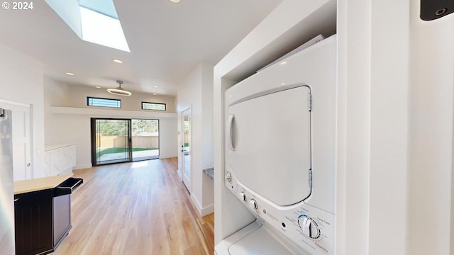 94256 11th St, Gold Beach, OR 97444 - laundry area with stacked washer / dryer, light wood-type flooring, a skylight, recessed lighting, and baseboards