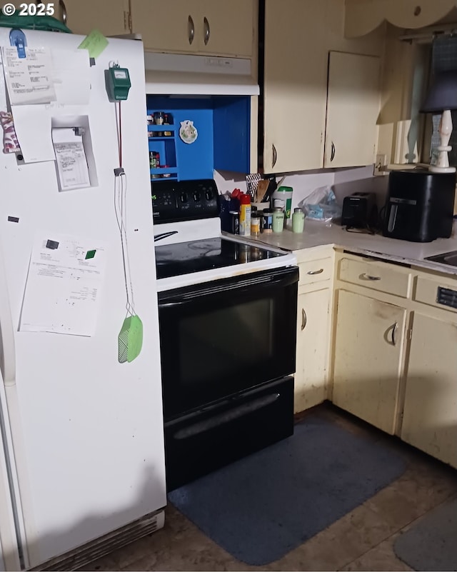 kitchen featuring white appliances and cream cabinets