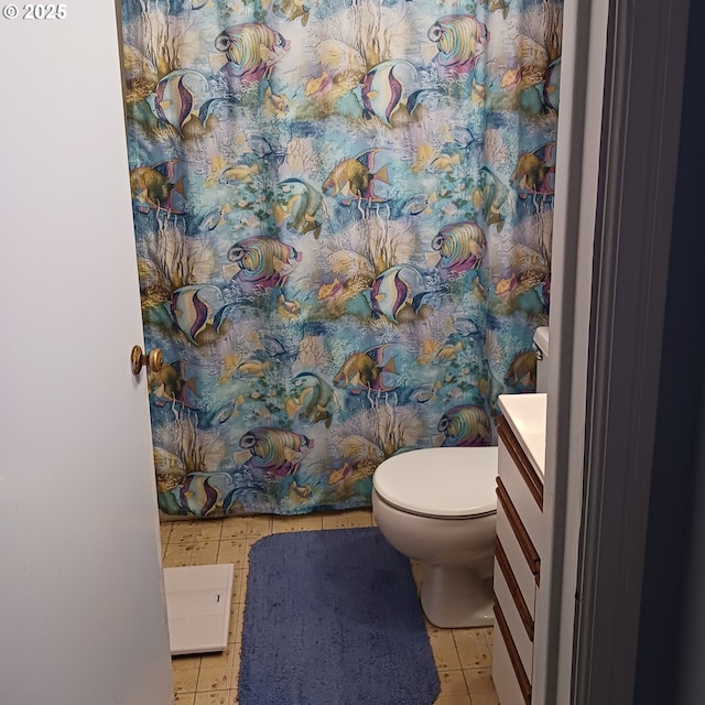 bathroom with tile patterned floors, vanity, and toilet