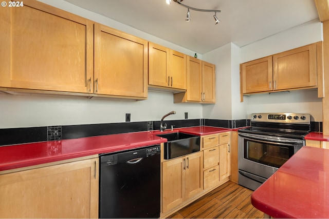 1220 NE 17th Ave Unit 4C, Portland, OR 97232 - kitchen featuring stainless steel electric stove, dishwasher, a sink, dark wood finished floors, and dark countertops