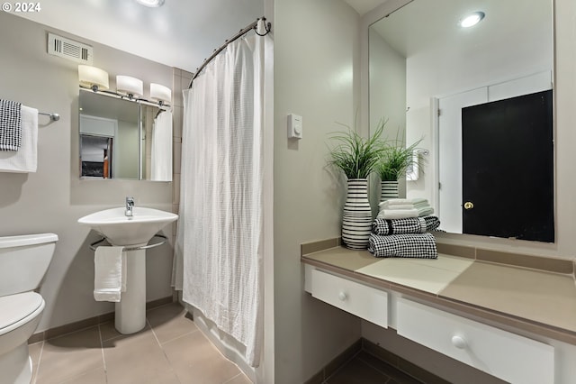 1220 NE 17th Ave Unit 4C, Portland, OR 97232 - full bath with toilet, baseboards, tile patterned flooring, and a shower with shower curtain
