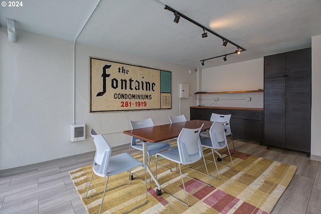 1220 NE 17th Ave Unit 4C, Portland, OR 97232 - dining room featuring track lighting, light wood finished floors, and heating unit
