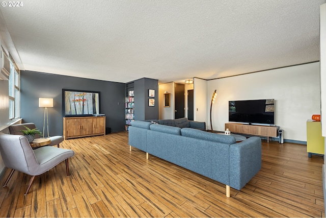 living room with hardwood / wood-style floors and a textured ceiling