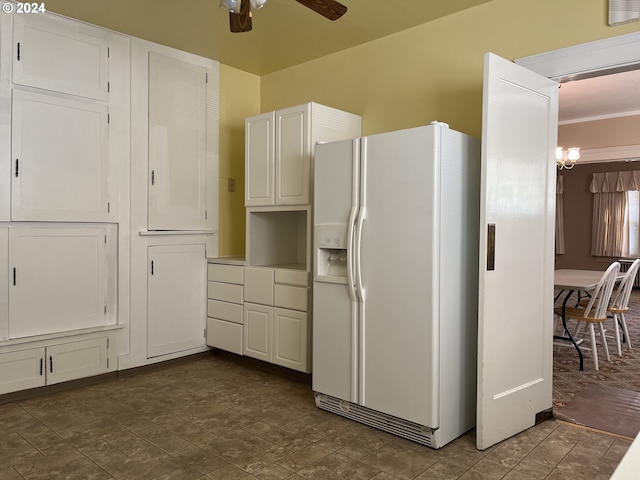 kitchen featuring ceiling fan with notable chandelier, white cabinets, and white fridge with ice dispenser