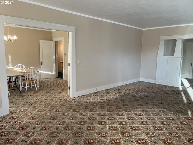 spare room featuring a chandelier, a textured ceiling, and crown molding