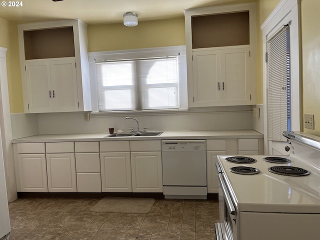 kitchen with sink, white appliances, and white cabinetry