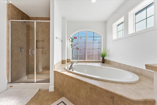 bathroom featuring shower with separate bathtub and tile patterned floors