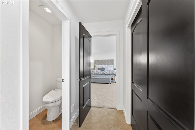 bathroom with tile patterned flooring and toilet