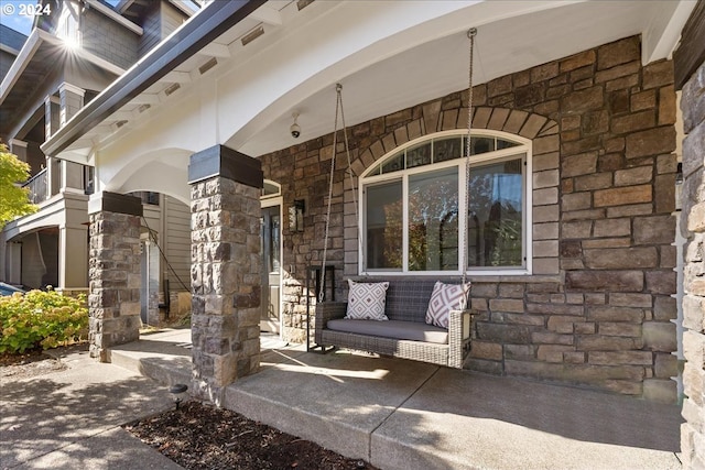 view of exterior entry with a porch