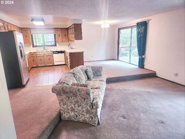 kitchen with stainless steel fridge, dishwasher, light carpet, and a textured ceiling