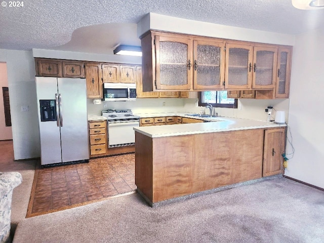 kitchen with carpet, appliances with stainless steel finishes, a textured ceiling, and kitchen peninsula