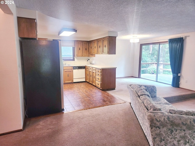 kitchen with light carpet, dishwasher, refrigerator, and a textured ceiling