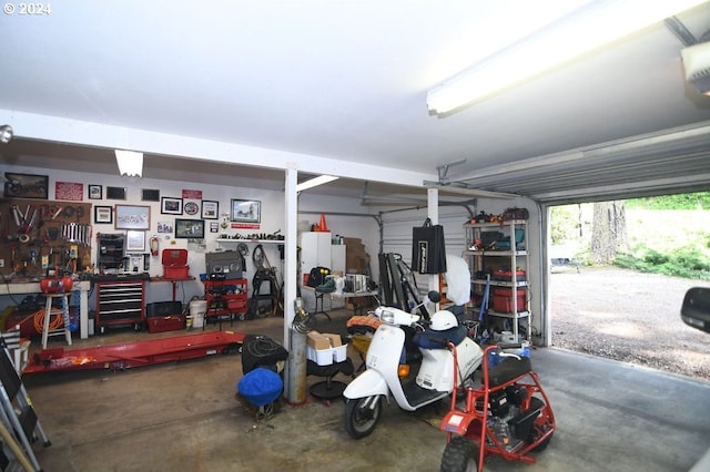 garage with a workshop area and a garage door opener