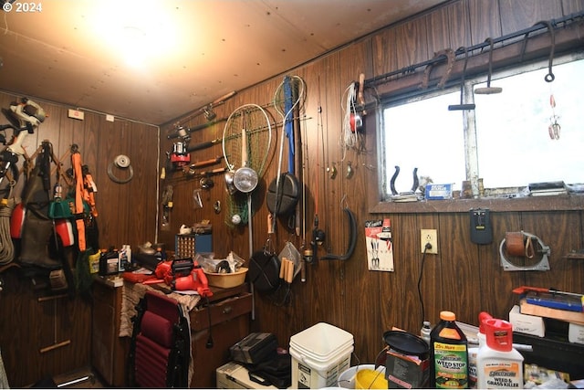 misc room featuring a workshop area and wooden walls