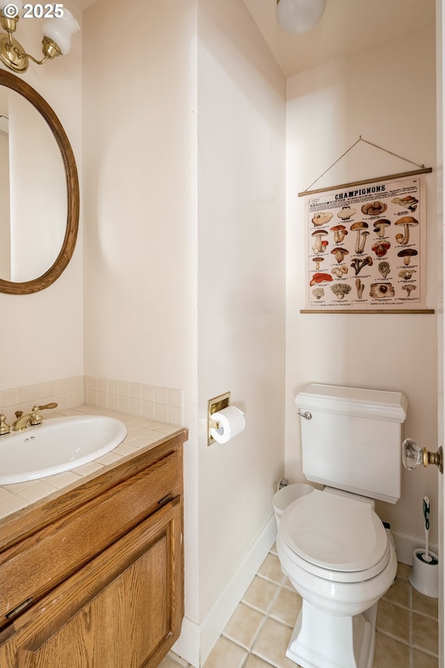 bathroom featuring vanity, toilet, and tile patterned flooring