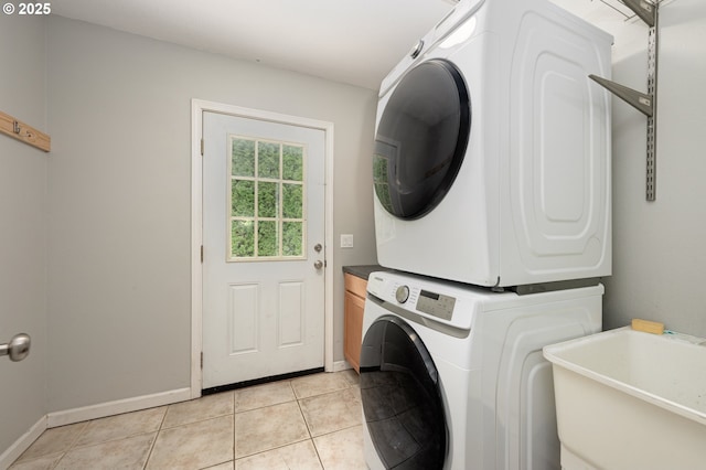 2823 SE Olsen St, Milwaukie, OR 97222 - laundry area with stacked washer / dryer, light tile patterned flooring, and baseboards