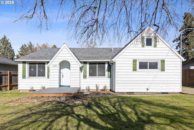 back of house with a lawn and a deck