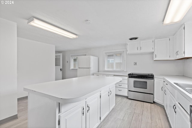 kitchen with white cabinetry, stainless steel electric range, light hardwood / wood-style flooring, a kitchen island, and white refrigerator